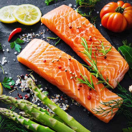 Fresh salmon fillet with aromatic herbs, spices and vegetables. Balanced diet or cooking concept